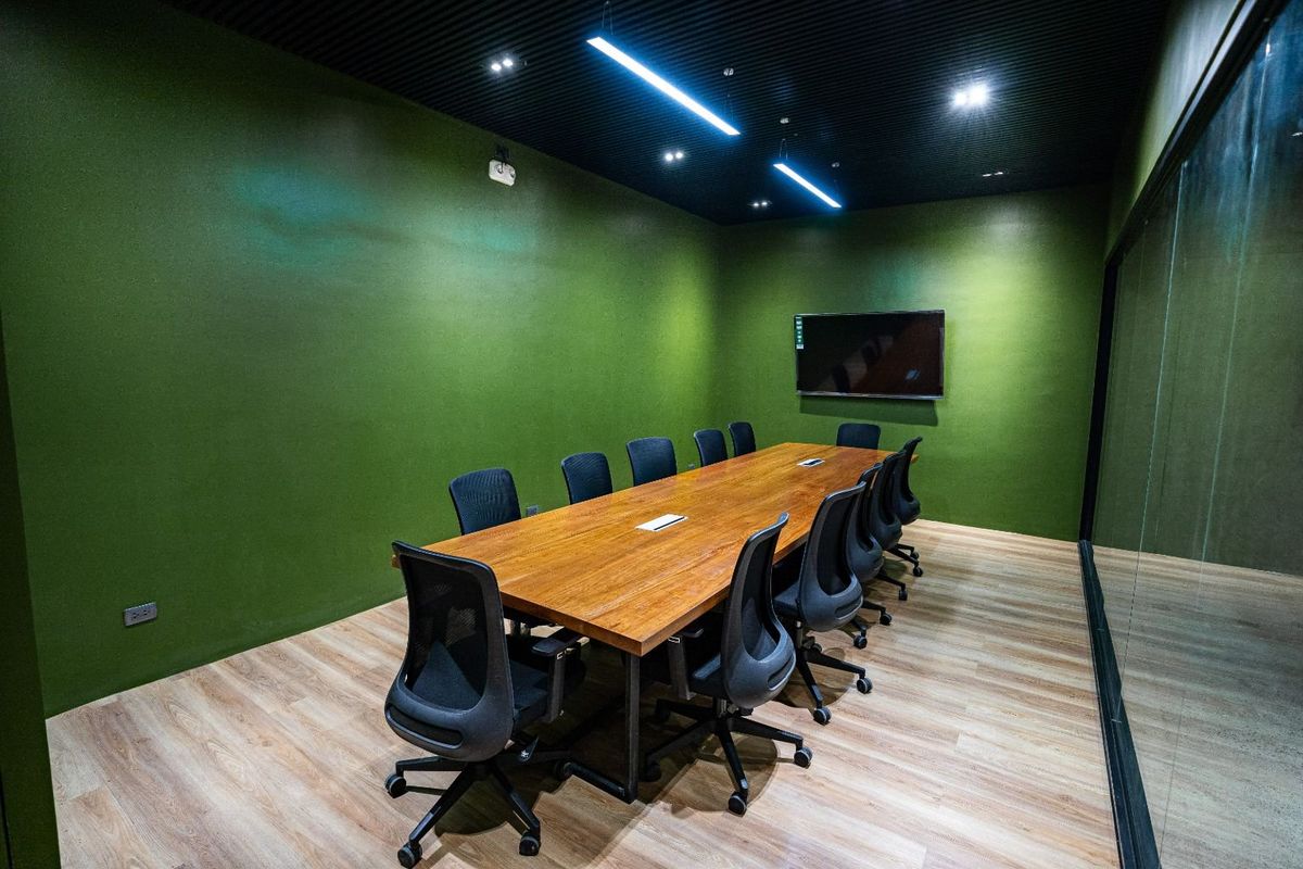 The large meeting room with a long wooden table for twelve