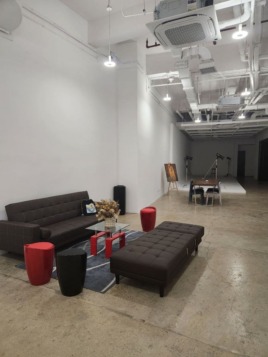 The studio lounge with dark sofas